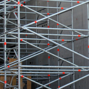 Construction worker raising pallets of materials