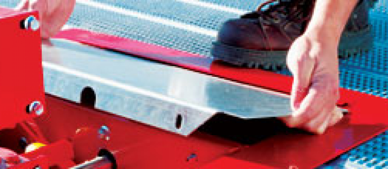 sidebar-service A man placing a metal sheet against a cutting tool